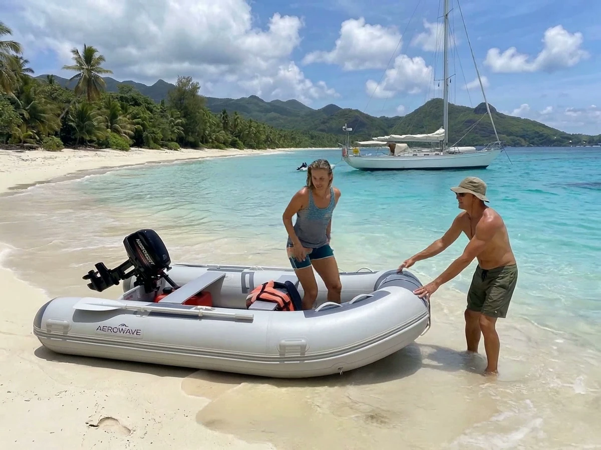 Aerowave Swift inflatable tender shown on a beach with a yacht offshore